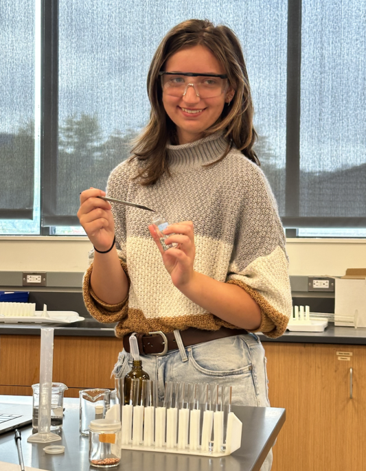 Woman in a lab wearing safety goggles
