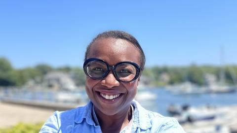 Woman with glasses outside by water
