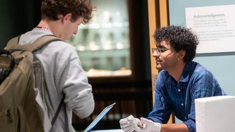 Ashwin Sivakumar, at right, shows off specimens from the Harvard Museum of Natural History collection. Tony Rinaldi