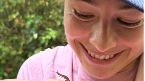 Arianna Lord holding a new undescribed species of velvet worm from Singapore