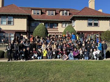 OEB staff posing in front of a building in Brewster, MA for a department retreat