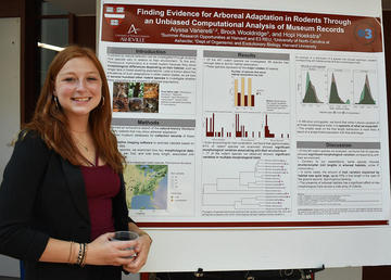 Woman standing in front of a poster