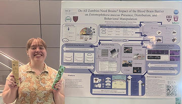 Woman standing in front of a science poster