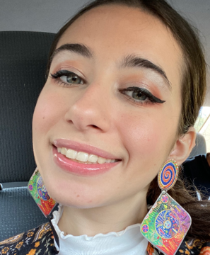 Woman wearing large earrings smiling
