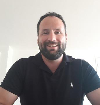 Man with a beard wearing a black top