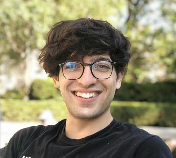 Man wearing glasses sitting outside