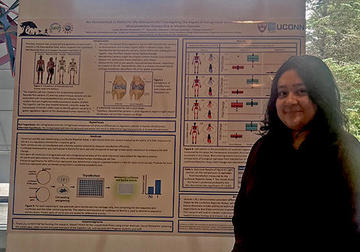 Woman standing in front of a science poster