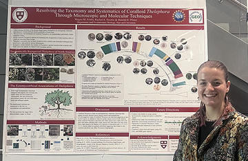 Woman standing in front of a science poster