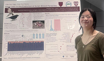 Woman standing in front of a science poster