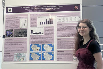 Woman standing in front of a science poster
