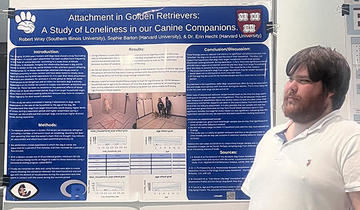 Man standing in front of a science poster