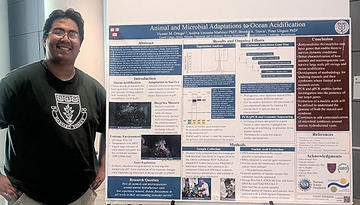 Man standing in front of a science poster