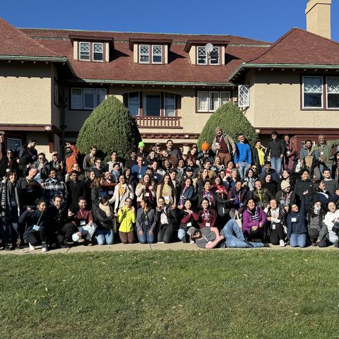 OEB staff posing in front of a building in Brewster, MA for a department retreat