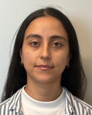 Diana Martinez Baquero with long dark hair wearing a striped shirt