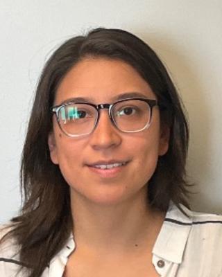 Portrait of postdoc Francesca Ponce wearing glasses and a white shirt