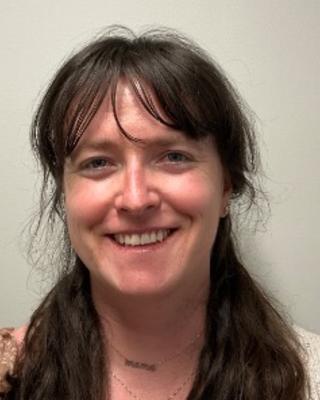 Portrait of postdoc Jennifer McCarthy-Taylor wearing a white sweater