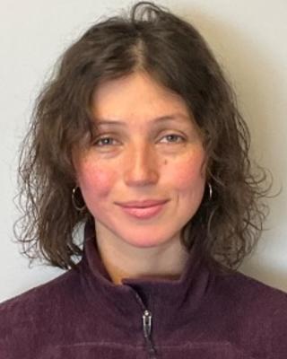 Portrait of postdoc Tatiana Ruiz Bedoya wearing a maroon jacket
