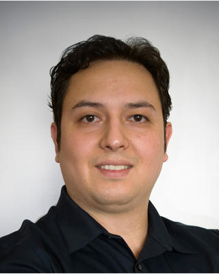 Portrait of postdoc J. Antonio Guzman Q wearing a black shirt against a white background