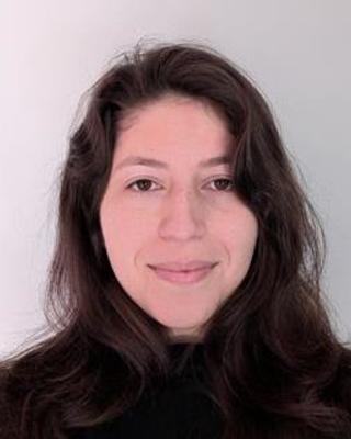 Portrait of PhD candidate Joanna Shoubaki wearing a black top