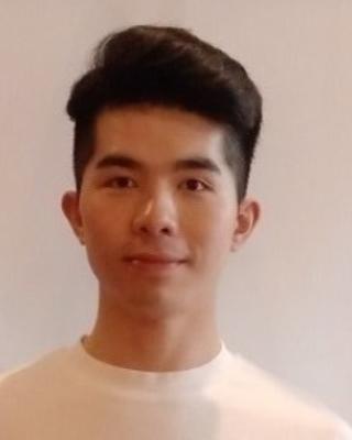 Bohao Fang with tall dark hair and a white shirt, in front of a light grey background