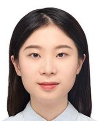 Jingting Liang with long black hair, wearing a light colored top, in front of white background