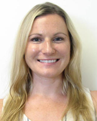 Molly Gabler with long blonde hair, wearing white sleeveless shirt, white background