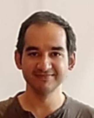 Sahil Moza with short brown hair and a brown shirt, in front of beige background