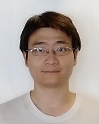 Shaoqing Liu with dark hair, wire glasses, white tshirt, against white background