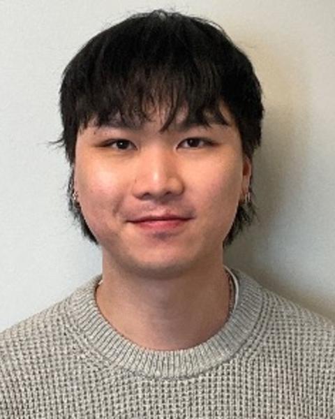 Portrait of postdoc Aaron Lee wearing a gray shirt