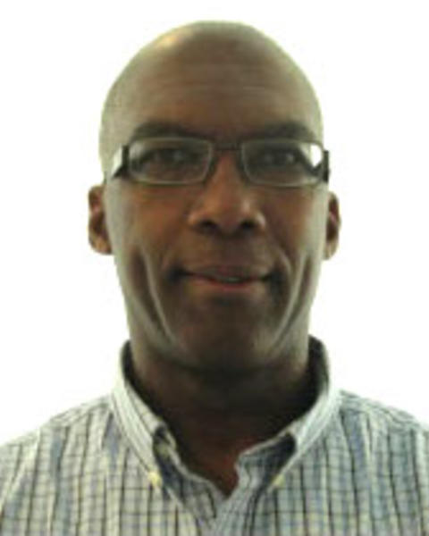 Irv Dumay with black glasses, light check shirt, white background