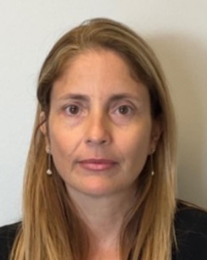 Aylin Alegre Barroso with long dark blonde hair and a black top, in front of beige background