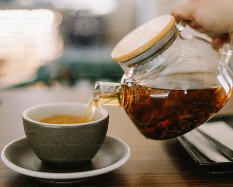Pouring tea into a cup