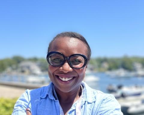 Woman with glasses outside by water