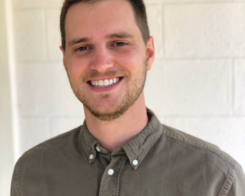 Man in a gray button up shirt